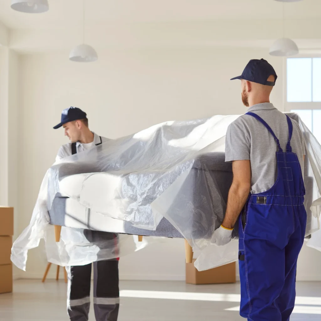 Furniture Moving Services team lifting a sofa carefully